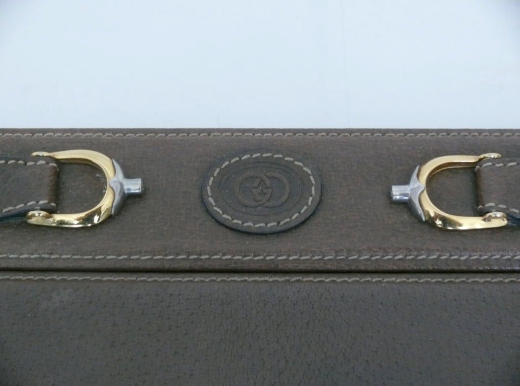 Original vintage Gucci desk blotter in brown leather with handsome brass buckle detail.  Stamped with Gucci logo on back. Nice patina and age to leather.
