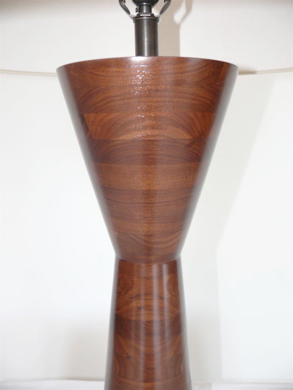 Sleek solid walnut wood lamp made of stacked butcher block wood and newly refinished. Professionally rewired with new linen shade.