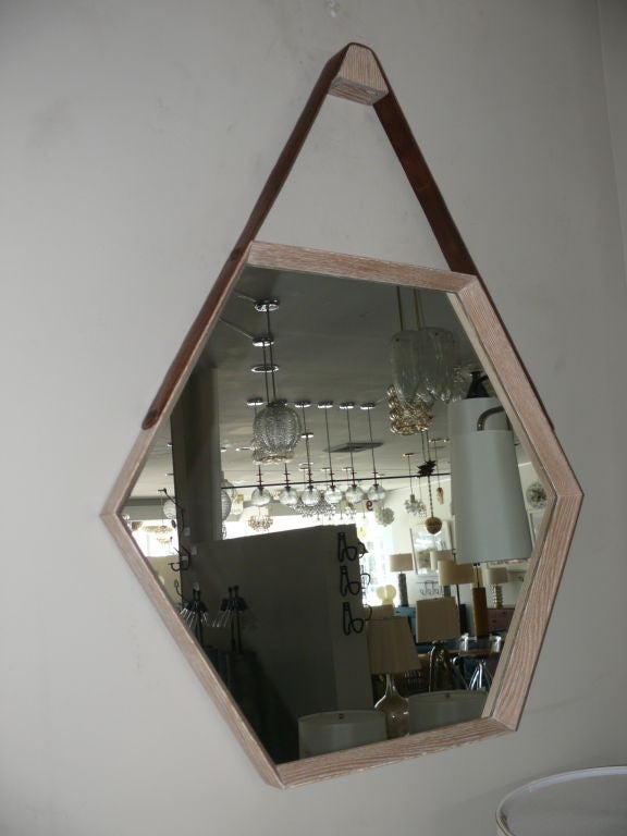 Newly produced cerused oak wood hexagon mirror with leather strap detail attached to studs.  Clean and simple design.  Multiple quantity and finishes available.