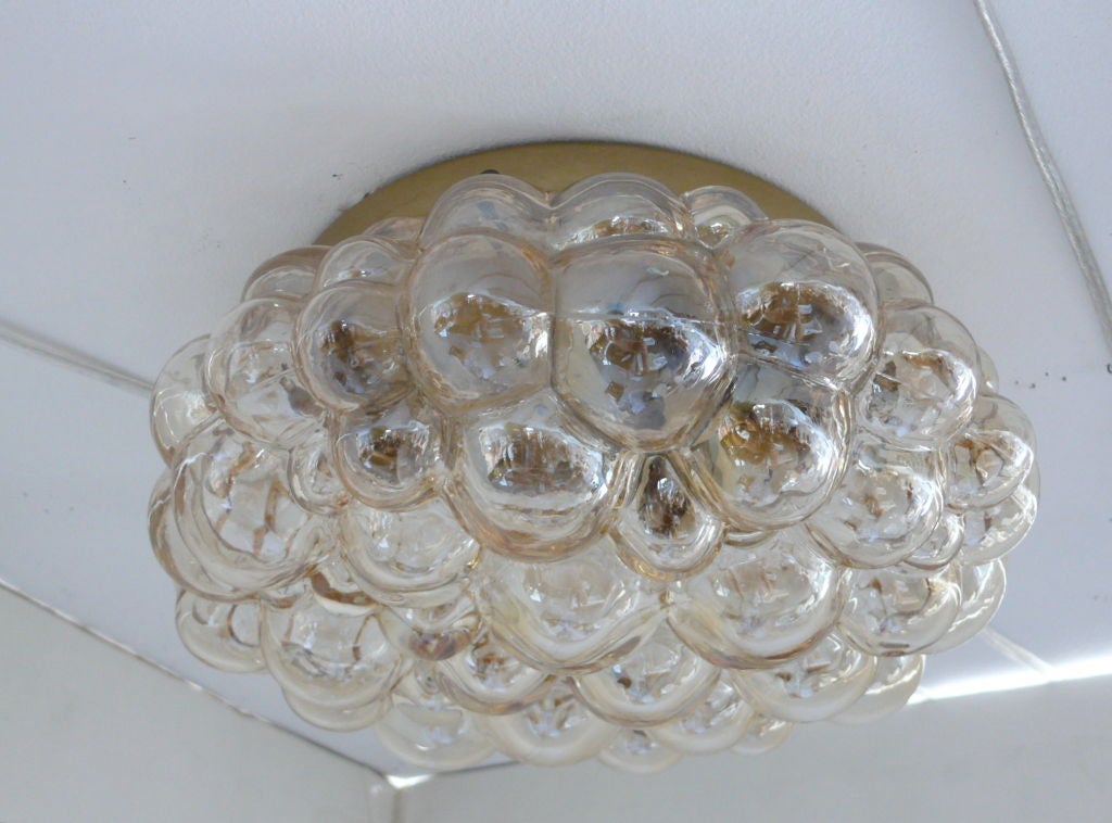 Beautiful bubble glass flush mount ceiling fixtures with brass hardware. Thick bubble glass has light amber color tones and was handblown and finished by hand. Professionally rewired.