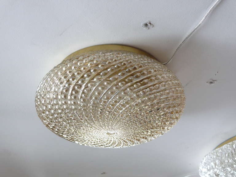 Delightful amber glass Italian flush mount. Beautiful circular shape with bubbled textured swirl pattern in glass.  Stunning glow. Brass fixture and newly re-wired.