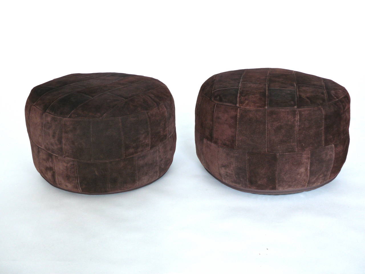 Fanstastic pair of chocolate suede, patchwork ottomans by De Sede. Original suede in excellent condition. Filled with beans. Perfect size.