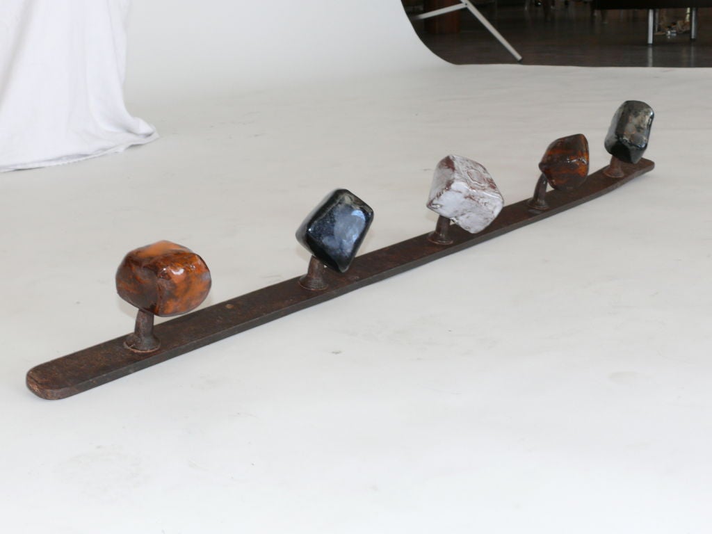 Stunning multi-color ceramic and iron coat rack. Five individual and free formed jem-style knobs with vibrant ceramic glaze.