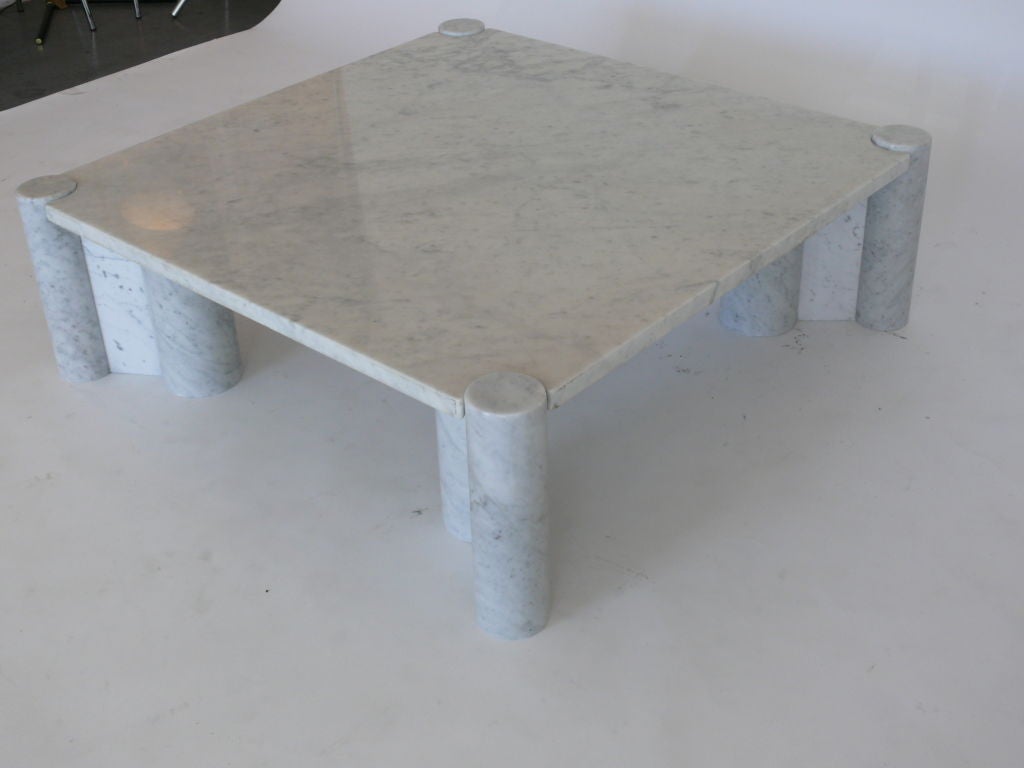 Beautiful large marble coffee table designed by Gae Aulenti for Knoll International. Four solid columnar legs support square top with interlocking corners.