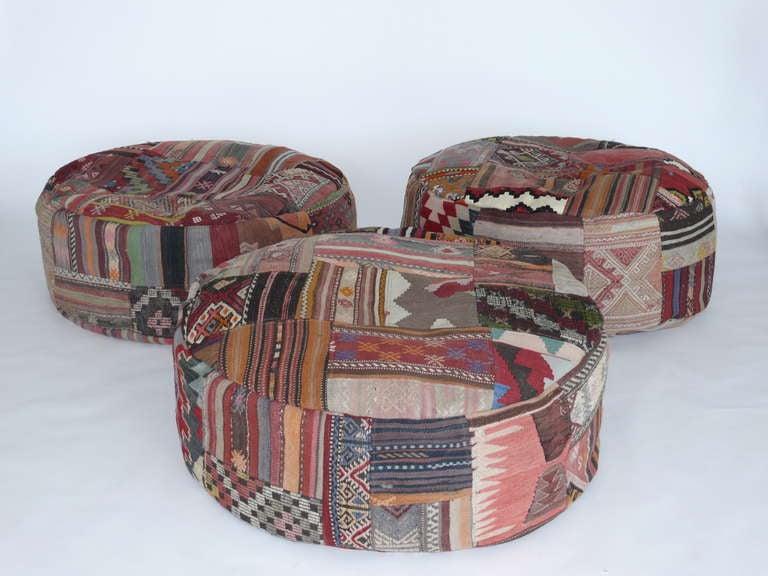 Fantastic large sized ottoman poufs made of beautiful Turkish textiles. Over 100 year old fabric has been pieced together to create a stunning patchwork of vibrant colors, patterns, and textures. Very large and perfect to sit, lay on, or use as a