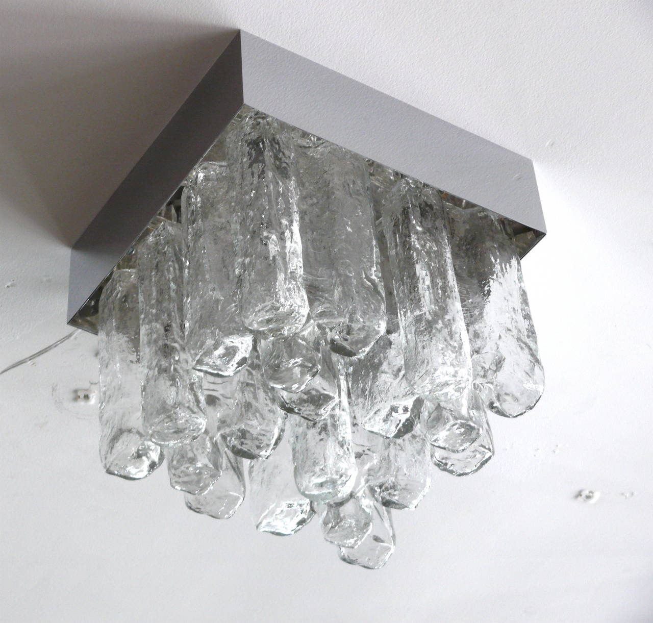 Kalmar flush mount with hanging thick cut Granada glass. Glass hangs from polished chrome base. Perfect scale.