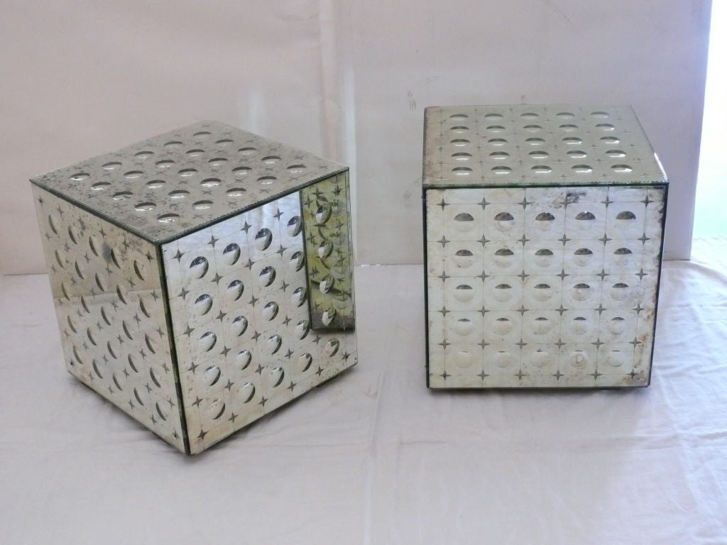 Great pair of mirrored cubes with convex circles and etched stars. Cubes sit on wheels for easy mobility. Fantastic patina to mirror and can be used as end tables or occasional tables.