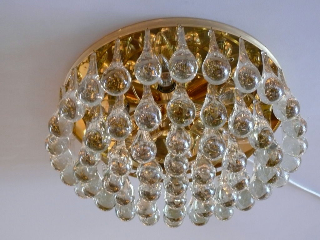 Gorgeous glass tear drop flush mount with 5 rings of solid glass tear drop shape pieces individually dangling from polished brass fixture. Newly re-wired.