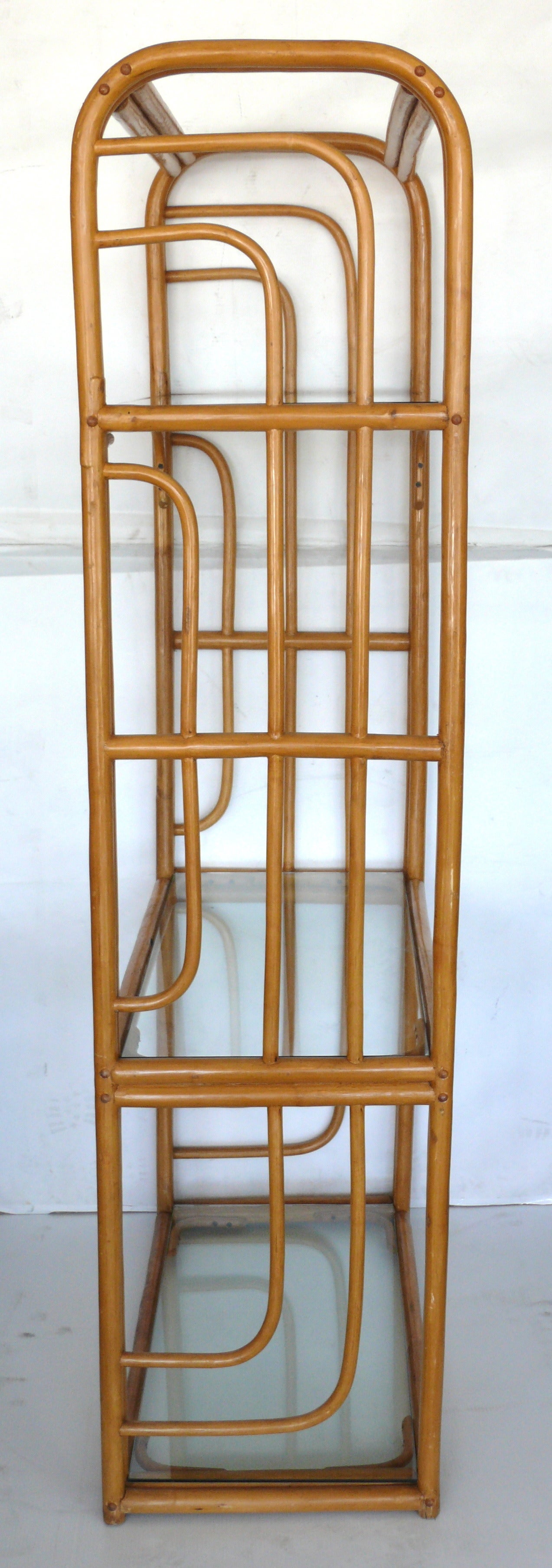 Fantastic pair of bamboo bookshelves. Three newly made glass shelves rest on bamboo frame. Great lines and clean design. Two available priced individually.