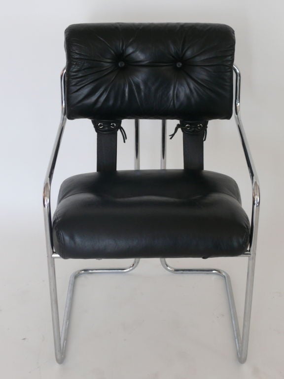 Mariani for Pace Collection dining chairs. Simple tubular chrome base with soft black leather. Fantastic leather corset detailing in the back with leather straps. Priced as a set of 8 for $15,500.