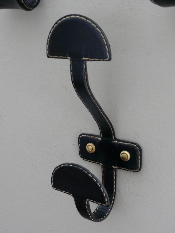 Single coat hook wrapped in leather with contrast stitching. Newly produced and multiple available.