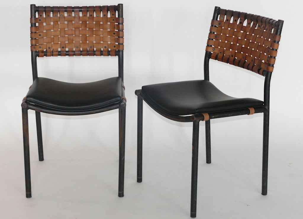 Unique artisanal woven leather and iron chairs. <br />
New black leather seat.