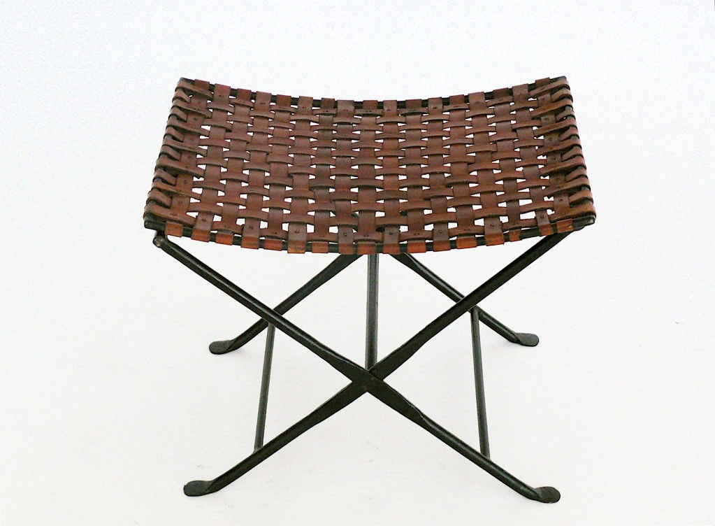 Unique artisanal woven leather and black iron imperialistic style stools, the leather with incredible patina and maker's hammer marks on iron at leg connections.