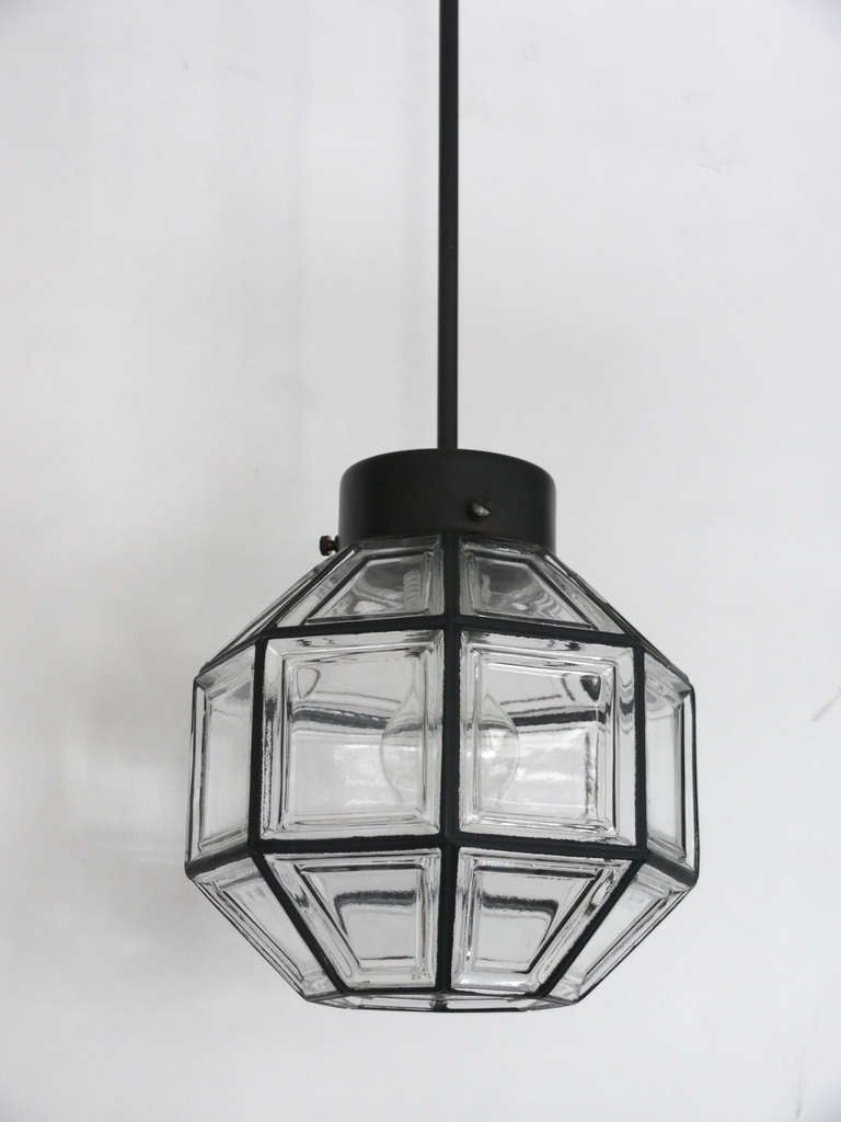 Simple and elegant iron and glass pendants. Glass globe shaped as an octagon with inlaid iron with in clear glass. Oil rub bronze hardware. Newly re-wired. One available.