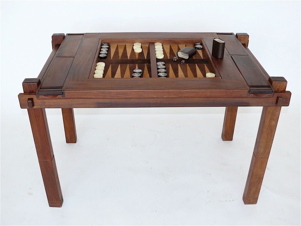 Handsome reversible craftsman backgammon, chess, and checkers table, the body made of a beautiful rosewood. The brown and cream suede leather top has matching colored chess pieces from S. Kind & Sons in Philadelphia.