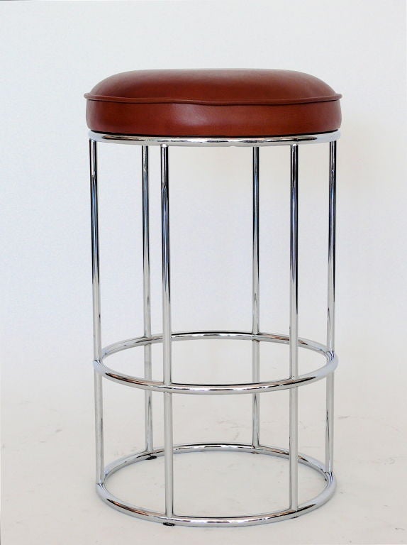 Set of four tubular chrome stools.  Newly upholstered in a carmel brown leather. Simple clean lines. Standard counter height but can be made in bar height. Multiple finishes available. 

Priced individually.