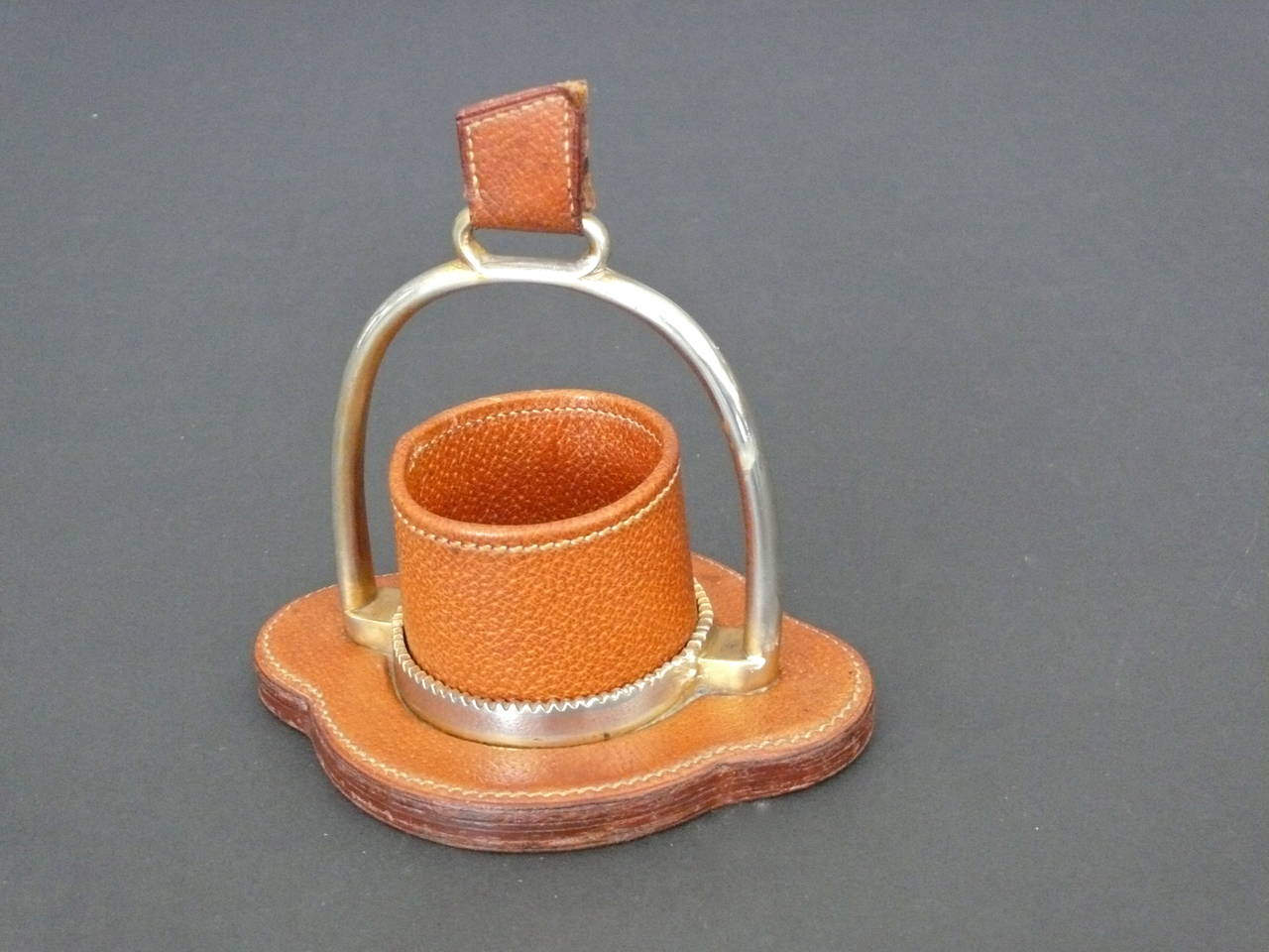 Handsome French cigarette holder or pen holder by Longchamps. Saddle leather with contrast stitching throughout. Brass stirrup and hardware with inset leather cup. Excellent vintage condition. Great accessory!