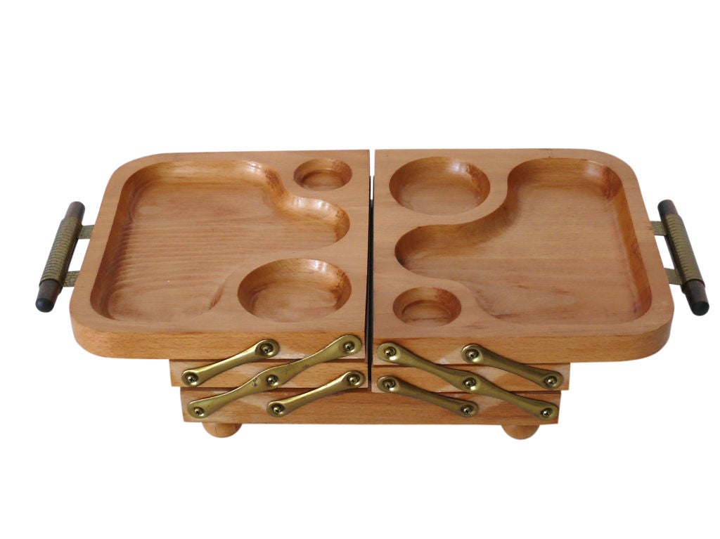 Intriguing fold-out organizing tray made by Karoff. Originally used as a buffet server and showcased in the book The Atomic Kitchen, this beautiful piece now makes an excellent tiered jewelry box. The brass hinges open to reveal three tiers at 30