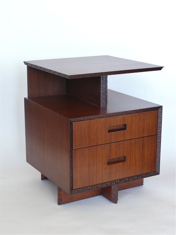 Frank Lloyd Wright designed nightstands manufactured by Heritage Henredon with floating top and two drawers. Distinct carvings from the Taliesin Line, which was named after Frank Lloyd Wright's home in Spring Green, Wisconsin. Matching dressers