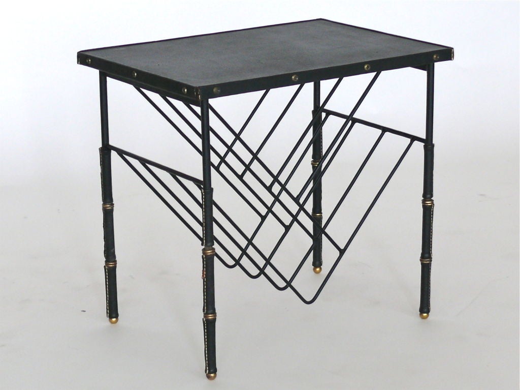 Jacques Adnet side table with signature black leather and brass bamboo legs and skai top. Brass hardware detailing and angular iron wire bookshelf built-in.