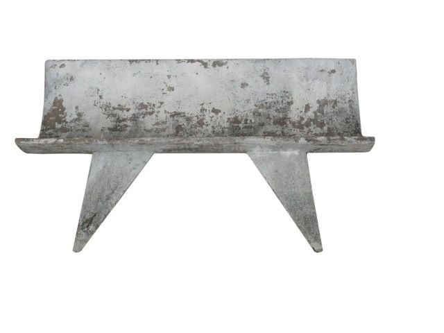 Incredible cast concrete bench, the scoop barrel seat resting on open angular legs. Beautiful wear to the concrete surface. Captivating, unique design.<br />
<br />
Two available. Priced individually.