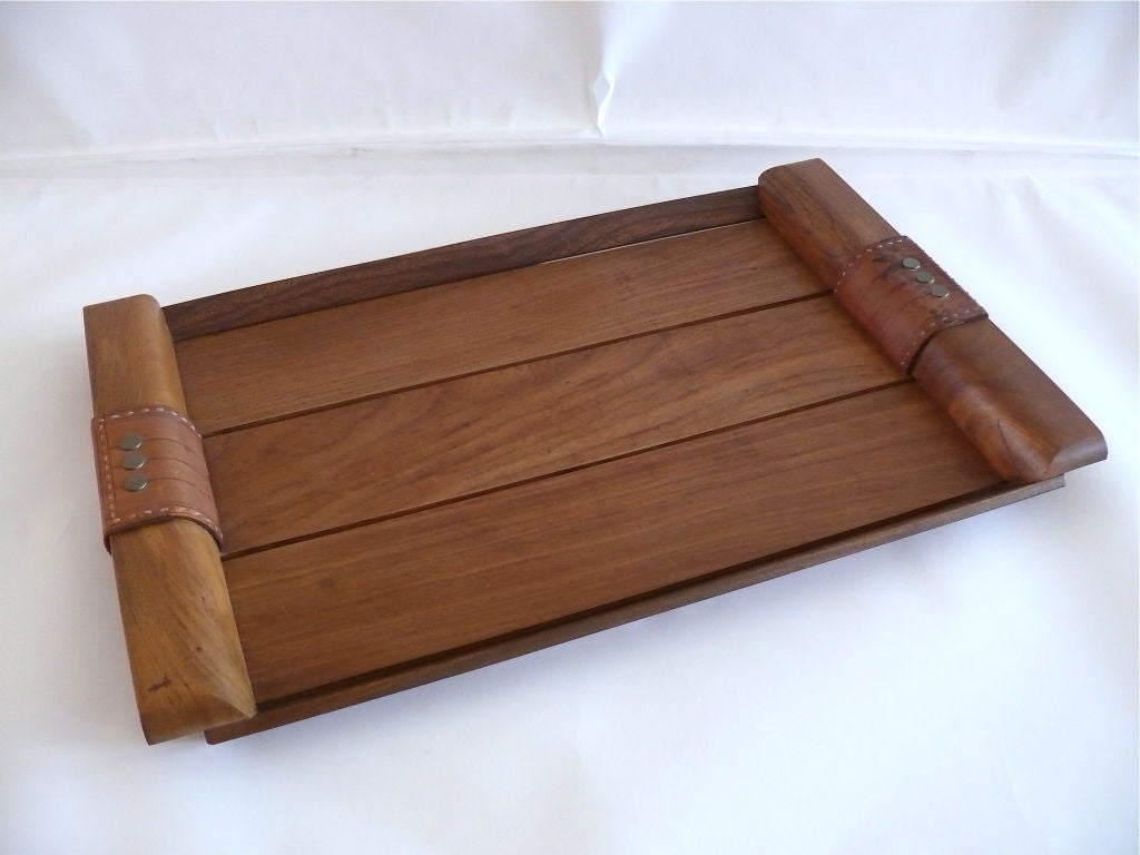Large oak serving tray by Jacques Adnet with light brown stitched leather handles detailed with three flat brass studs. Gorgeous patina to leather handles.