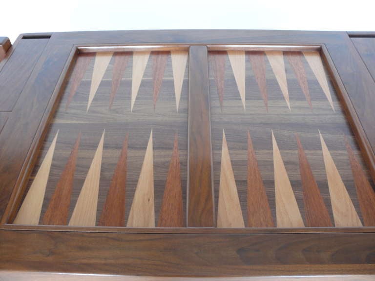 Handsome, newly produced backgammon table. Stunning architectural frame made of walnut wood and newly refinished. Backgammon board has beautiful mixture of mahogany and beech wood for contrasting colors. Board comes out and is reversible. Reverse
