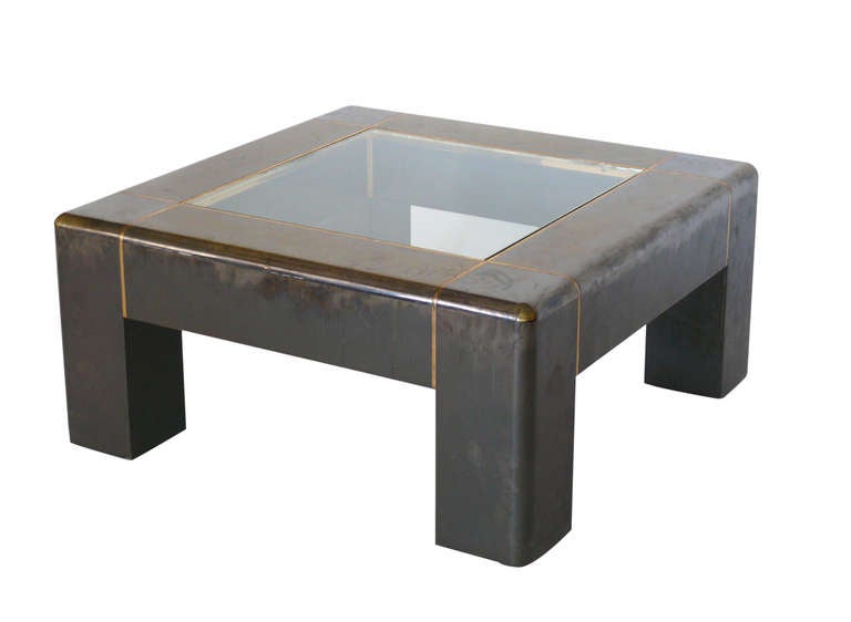 Original and rare square Karl Springer Coffee Table. Solid and extremely heavy table with gunmetal finish and brass detailing. Clear center glass. Original finish has markings and signs of wear consistent with age. Beautiful and impressive piece.