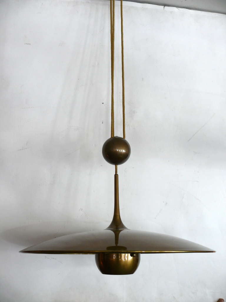 Beautiful Florian Schulz counter balance pendant in a polished brass finish. Newly rewired black cloth twist covered cord. Easily adjustable height. Good vintage condition. One minor scuff on brass disc. Additional pictures available upon request.