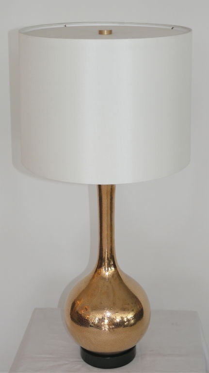 Beautiful pair of gold mercury glass lamps. Gold mercury glass with crackled texture and black wood base. Lovely globe shape and long neck with new silk shade. Professionally re-wired.