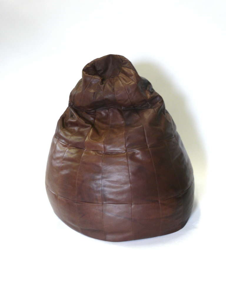 Supple vintage leather bean bag chair made from rich brown patches of leather. Large cone shape stuffed with mini foam beads. Gorgeous patina and coloring to leather - extremely comfortable. In the style of De Sede.