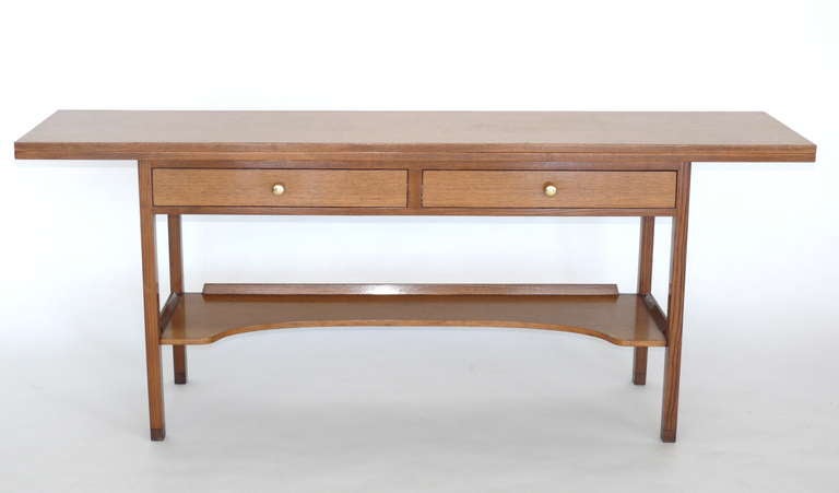 Great oak flip-top console table with two drawers and lower shelf. Top flips open to 35