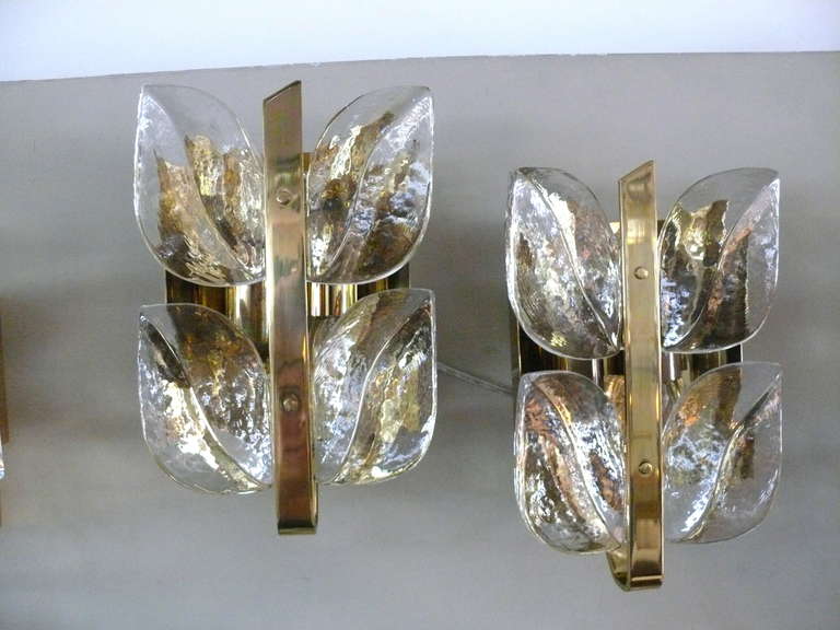 Stunning pair of Kalmar sconces with two rows of thick cut glass in the shape of leaf petals. Brass fixture and newly rewired. Unique and beautiful. Priced as a pair.