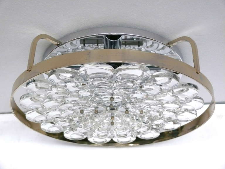 Circular Italian crystal flush mount with brass frame suspended from a polished nickel canopy. Scallop shaped crystals graduating in size from small to large, held by brass hardware. Newly rewired.  Great scale.