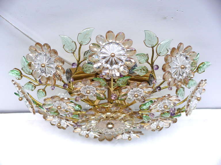 Beautiful crystal flower flush mount. Amber colored flower petals, green leaves and purple buds intertwined on a brass frame. Brass centers on flowers. Nice scale. Newly rewired.