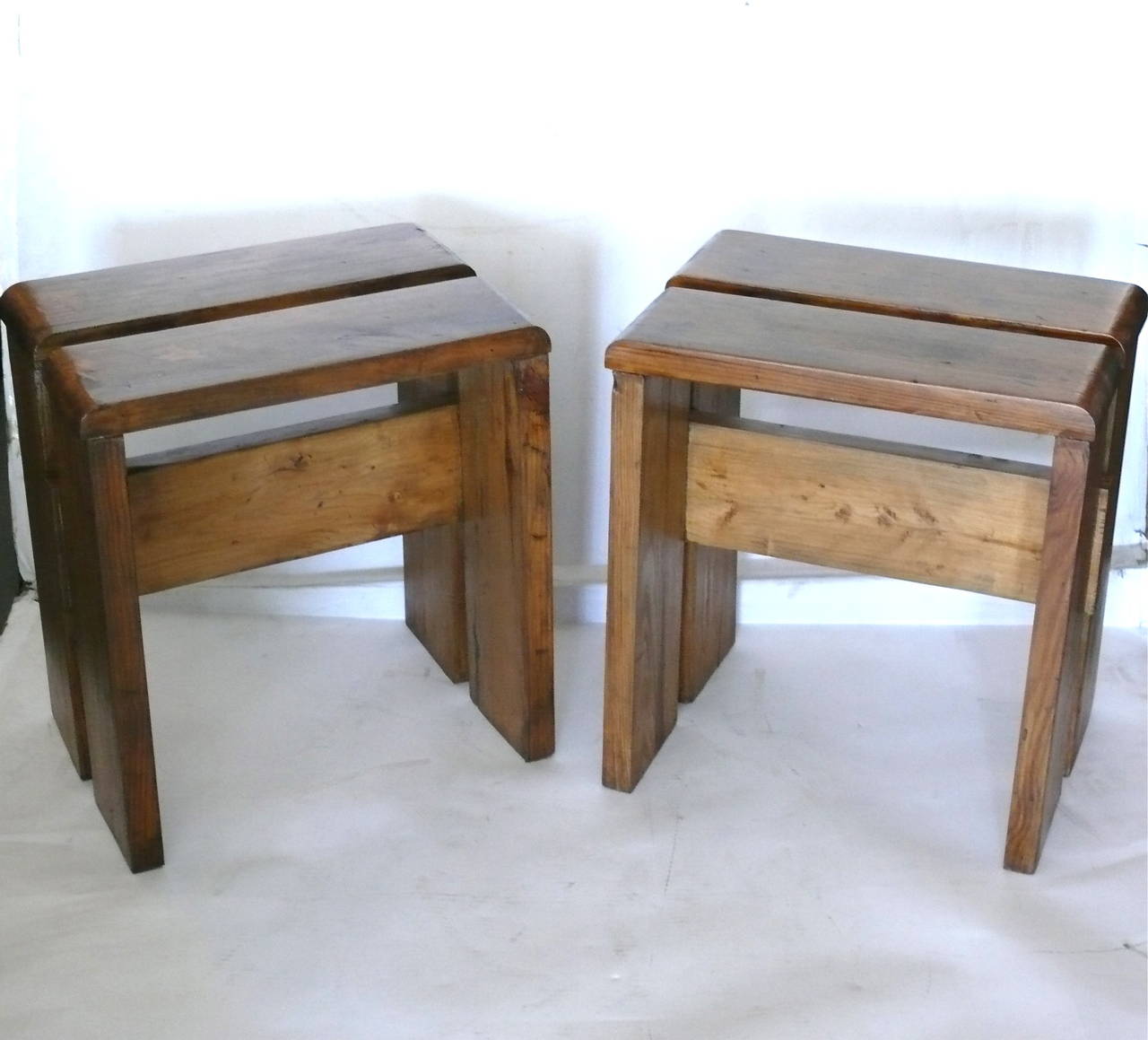 Fantastic pair of Les Arcs stools by Charlotte Perriand. Originally from the Les Arcs ski resort. French oak has great patina and wear.