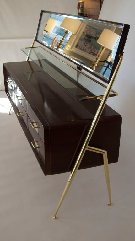 Rare Italian dresser by Silvio Cavatorta with 6 drawers, pivoting mirror and glass shelf. Newly refinished deep mahogany french polish finish. Polished Brass hardware has been newly plated and is not sealed so will patina beautifully.<br />
<br