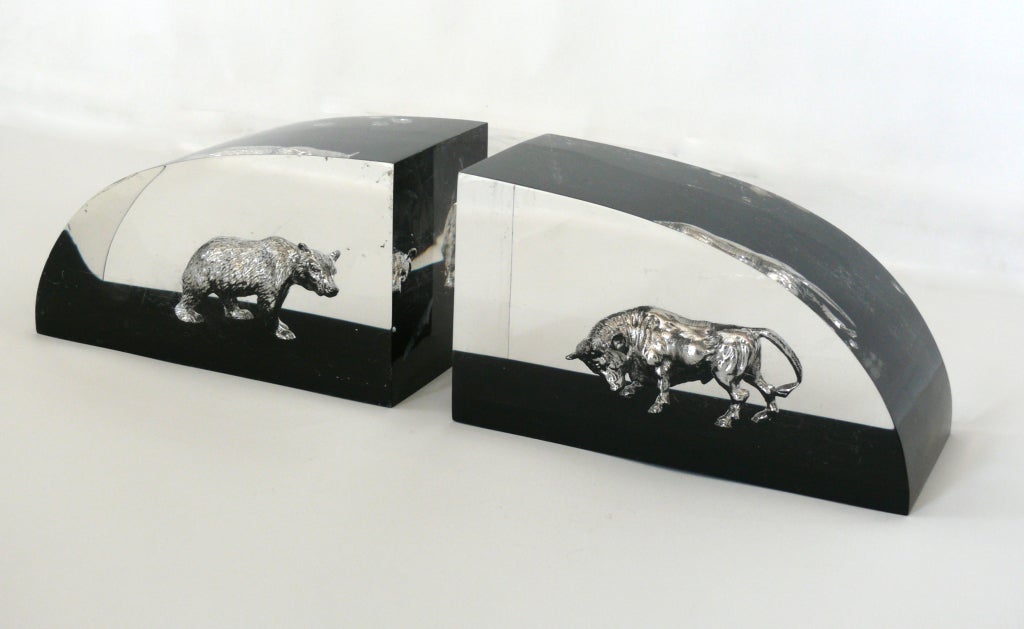 Unique pair of heavy lucite bookends with a silver bear and bull in the center of each. Both animals made of solid silver and with intricate detail. Great gift idea!