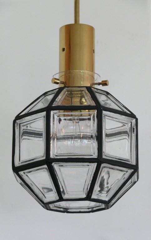Stunning Austrian glass pendant made of thick clear glass with inlayed iron framing each side of glass. Great lantern style octagon shape with brass hardware. Newly rewired.