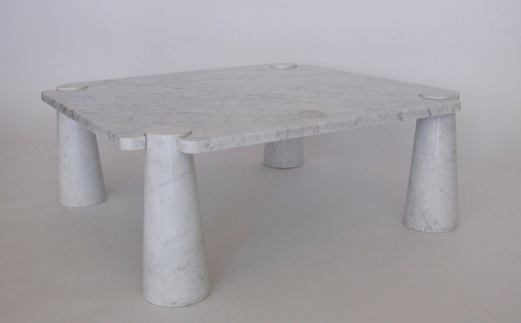 Incredible large marble coffee table designed by Angelo Mangiarotti. Four solid tapered columnar legs support square top with interlocking corners. Beautiful white carrera marble.