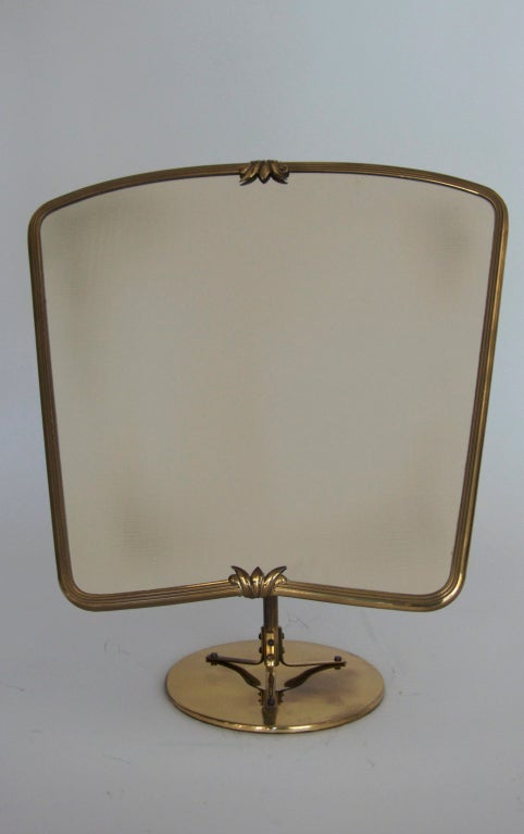 Elegant Italian vanity mirror in solid brass. Mirror adjusts at back to various angles. Nice patina and detailing.
