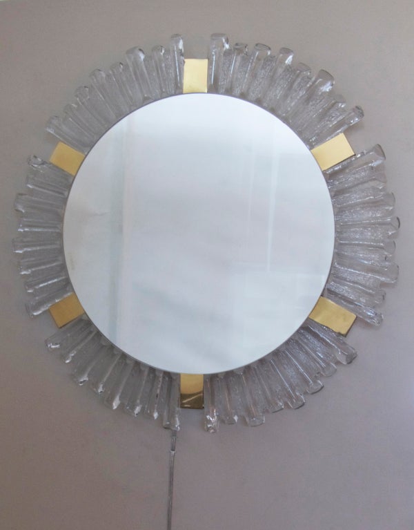 Stunning Austrian glass backlit wall mirror by Kalmar. Circular frame made of thick textured glass and brass detailing. Back light illuminates through glass edges to create soft and beautiful glow. Perfect for a powder room or vanity!