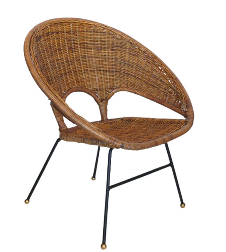 Fantastic pair of sculptural wicker and rattan scoop chairs. Low profile chairs have an iron frame and brass ball feet. Excellent vintage condition. Perfect for indoors and outdoors.