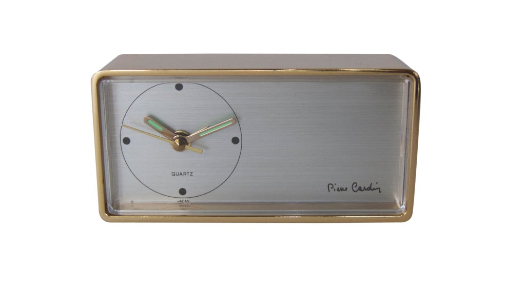 Classic petite French brass clock by Pierre Cardin. Heavy brass piece with signature on face. Also an alarm clock. Perfect gift!