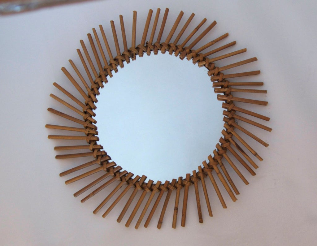 Incredible set of 5 vintage French sunburst mirrors made of bamboo and rattan. 4 Circular shapes in varying designs and 1 unique square sunburst mirror. Beautiful hung together as unique grouping. Two still available and sold individually.