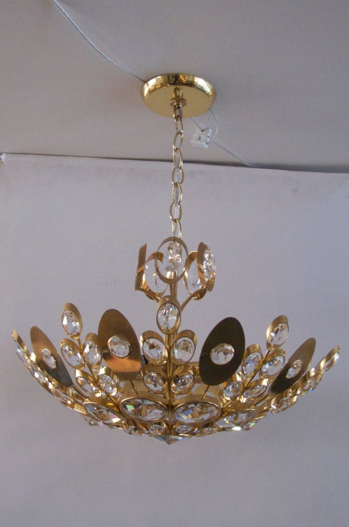 Stunning Italian ceiling light with sprouting vines of small and large crystals encircled in polished brass rings. Faceted crystal pieces illuminate beautifully. Incredible design and detail. Newly re-wired.