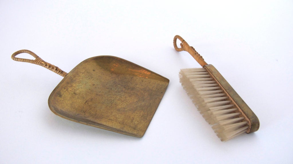 Beautifully crafted small scale dust pan and broom by Carl Aubock.  Gorgeous patina to the brass with wicker wrapped woven handles.  Fantastic functional object.

Dust Pan: 5.5