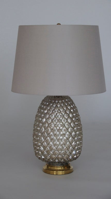 Beautiful pineapple shaped mercury glass lamp on brass bases. Silver metallic glass with incredible detailing in a rounded diamond design, brass stem and ball finial. Impressive in scale. Professionally re-wired and new silk shades.