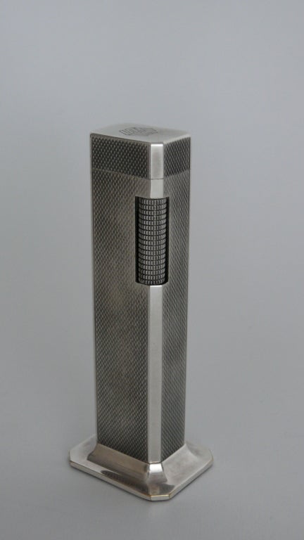 Fantastic silver lighter by Dunhill. Woven stamped silver and fluted base.  Stamped 