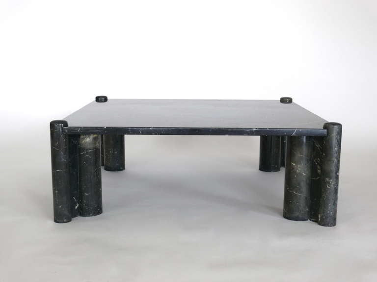 Impressive large black marble coffee table designed by Gae Aulenti for Knoll International. Solid marble top rests on four cylindrical pillar legs. Massive surface and low scale. Rare and exceptional piece in all original condition.